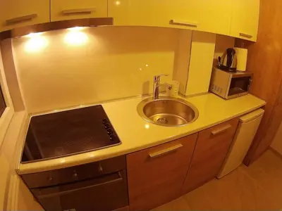 a small kitchen with a sink and a microwave at Balkan-inn Parlament Lux apartment in Belgrade