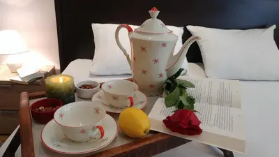 a tea set on a table with a tea pot and a lemon at Balkan-inn Parlament apartment in Belgrade