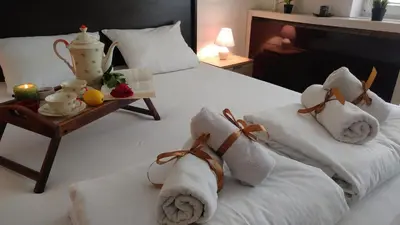 a hotel room with two beds with towels on them at Balkan-inn Parlament apartment in Belgrade