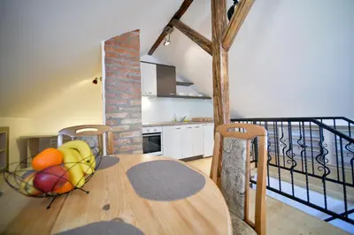 a kitchen with a bowl of fruit on a wooden table at Fd.Eight Apartment in Belgrade