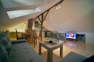 a living room with a couch and a table and a tv at Fd.Eight Apartment in Belgrade