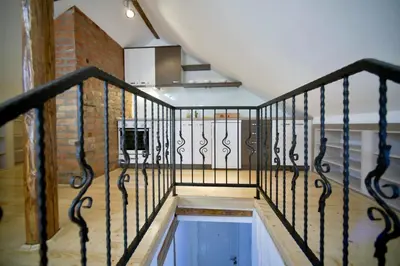 a staircase with a metal railing in a room at Fd.Eight Apartment in Belgrade