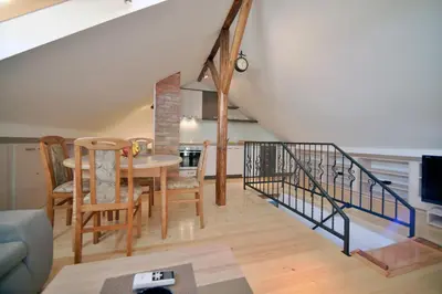 a dining room and living room with a table and chairs at Fd.Eight Apartment in Belgrade