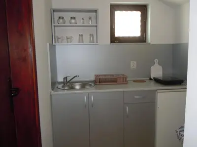 a small kitchen with a sink and a window at Apartmani Sobe BILJANA in Arandjelovac