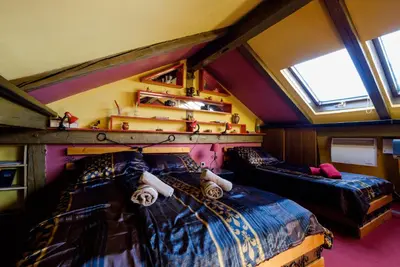 a bedroom with two beds in a room with a window at Apartment 14 in Belgrade