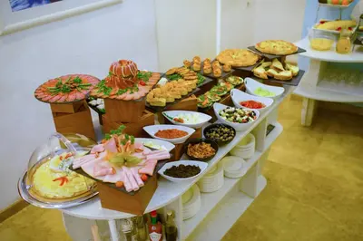 a table with a bunch of different types of food at Hotel City Savoy in Belgrade