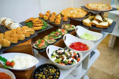 a buffet with many different types of food in bowls at Hotel City Savoy in Belgrade