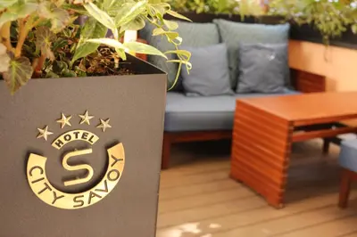 a box with a couch and a table in a room at Hotel City Savoy in Belgrade