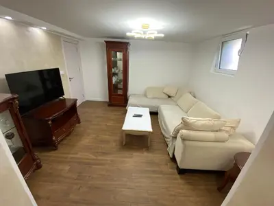 a living room with a couch and a flat screen tv at Baron Apartment in Belgrade