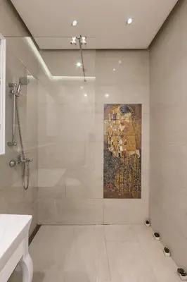 a bathroom with a shower with a painting on the wall at Max Luxury Apartments in Belgrade
