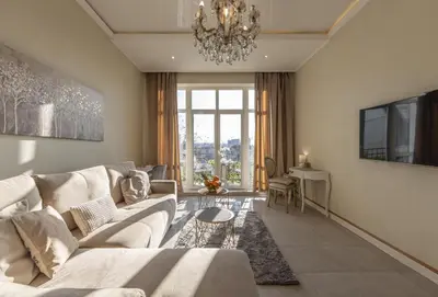 a living room with a couch and a chandelier at Max Luxury Apartments in Belgrade