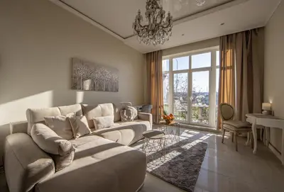 a living room with a couch and a large window at Max Luxury Apartments in Belgrade