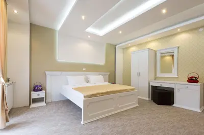 a bedroom with a white bed and a mirror at Sabor in Belgrade