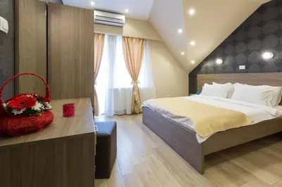 a bedroom with a large bed and a window at Sabor in Belgrade
