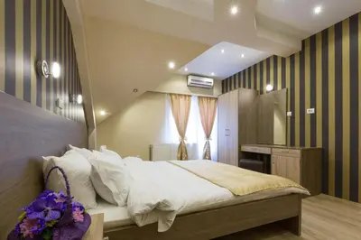 a bedroom with a large bed and a desk at Sabor in Belgrade