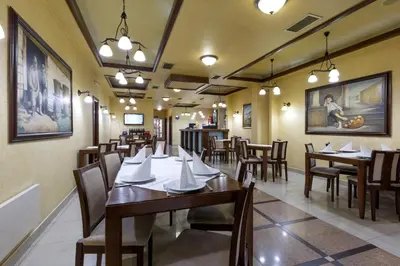a dining room with wooden tables and chairs at Sabor in Belgrade