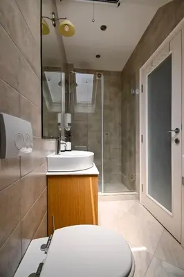 a bathroom with a toilet and a sink and a shower at Green and Blue Garden Apartments in Belgrade