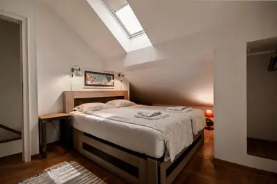 a bedroom with a bed and a skylight at Green and Blue Garden Apartments in Belgrade
