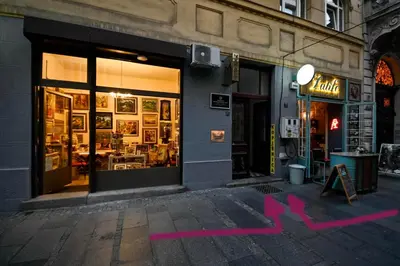 a store with pink writing on the side of a building at Green and Blue Garden Apartments in Belgrade