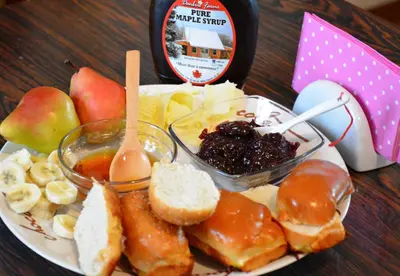 a plate of food with bread and fruit on a table at Cozy Downtown Apartment in Belgrade