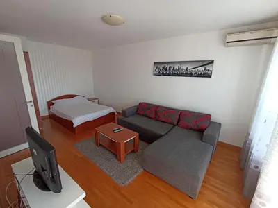 a living room with a couch and a bed at Apartment Tifani Belville in Belgrade