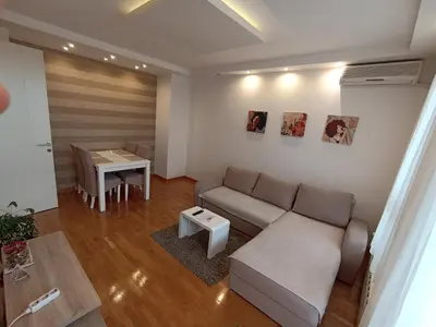 a living room with a couch and a table at Apartment Tifani Belville in Belgrade