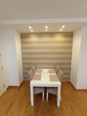 a white table and chairs in a room at Apartment Tifani Belville in Belgrade