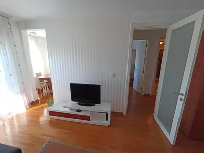 a living room with a tv on a white table at Apartment Tifani Belville in Belgrade