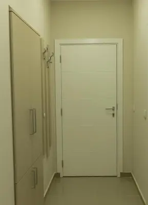 a white door in a hallway with a mirror at Apartments Jevremova in Belgrade