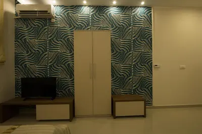 a room with a cabinet and a tv on a wall at Apartments Jevremova in Belgrade