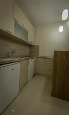 an empty kitchen with white cabinets and a sink at Apartments Jevremova in Belgrade