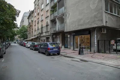 a small blue car parked on the side of a street at Apartments Jevremova in Belgrade