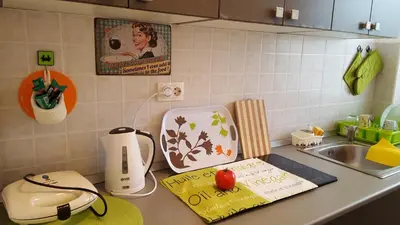 a kitchen counter with a hello kitty book on it at Apartment Greenfield in Belgrade