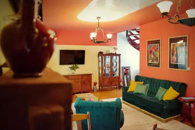 a living room with a green couch and orange walls at Marilyn Apartments in Smederevo