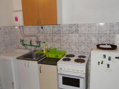a small kitchen with a stove and a sink at Studio Kalenic in Belgrade