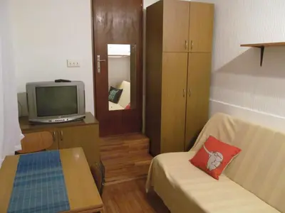 a small room with a tv and a couch at Studio Kalenic in Belgrade
