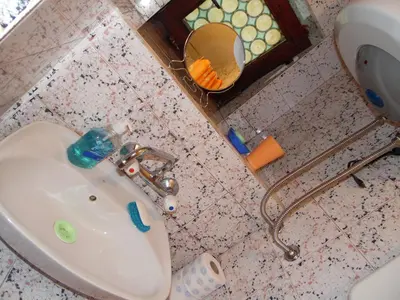 a bathroom sink with a mirror next to a toilet at Studio Kalenic in Belgrade
