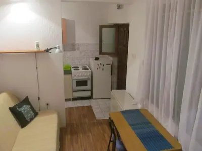 a small kitchen with a couch and a stove at Studio Kalenic in Belgrade