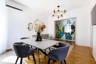 a dining room with a table and chairs at Belgrade CITY CENTER Apartments PARKING 12e - 7 min by walk TERAZIJE in Belgrade