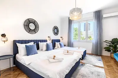 a bedroom with two beds and a large window at Belgrade CITY CENTER Apartments PARKING 12e - 7 min by walk TERAZIJE in Belgrade