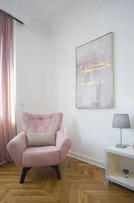 a pink chair sitting in a room with a table at Belgrade CITY CENTER Apartments PARKING 12e - 7 min by walk TERAZIJE in Belgrade