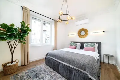 a bedroom with a bed and a potted plant at Belgrade CITY CENTER Apartments PARKING 12e - 7 min by walk TERAZIJE in Belgrade