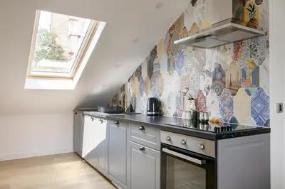 a kitchen with a counter and a tile wall at Belgrade CITY CENTER Apartments PARKING 12e - 7 min by walk TERAZIJE in Belgrade
