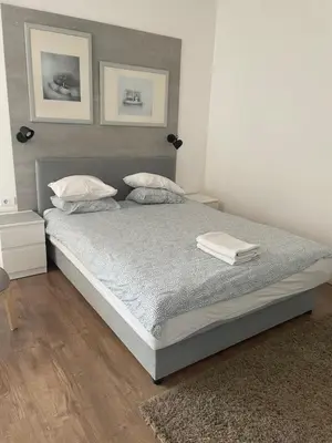 a bedroom with a large bed with two pillows at Slavija Square Apartments in Belgrade