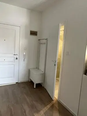 an empty room with a toilet and a door at Slavija Square Apartments in Belgrade