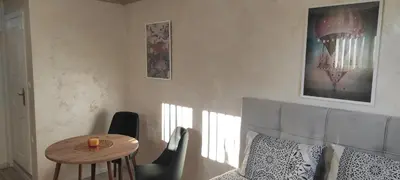 a room with a table and chairs and a table and a table sidx sidx sidx at Apartment Flora Arandjelovac in Arandjelovac