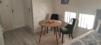 a small table in a room with a candle on it at Apartment Flora Arandjelovac in Arandjelovac