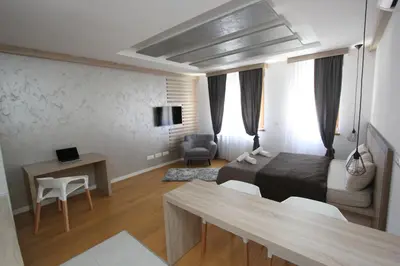 a bedroom with a bed and a desk and a table at New Belgrade Apartments Magnetic, parking 5 evra dan in Belgrade