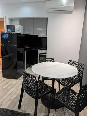 a white table and chairs in a kitchen at Top Belgrade Apartments in Belgrade