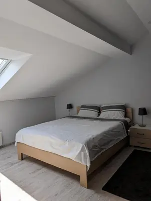a bedroom with a large bed in a attic at Top Belgrade Apartments in Belgrade